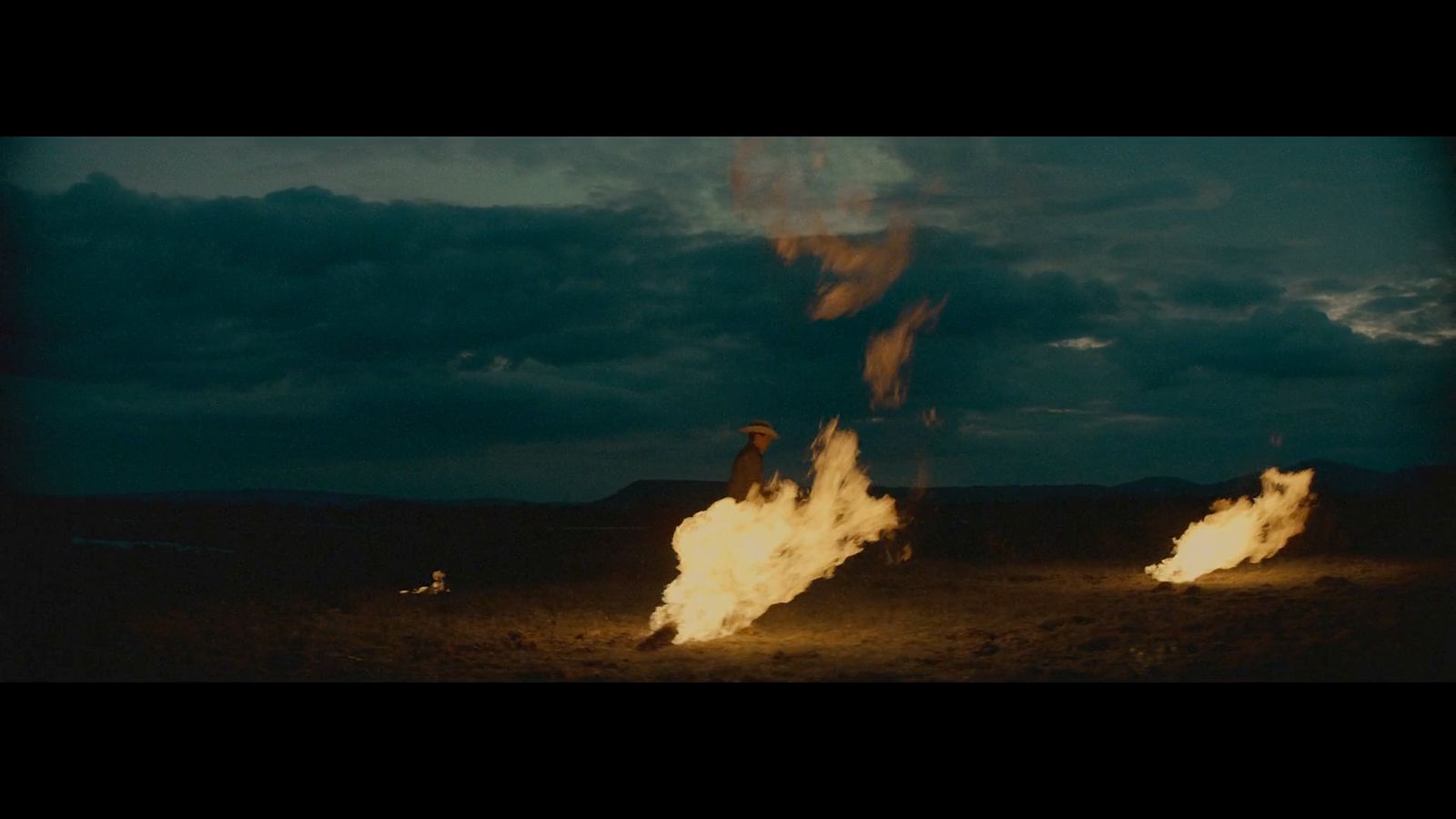 a group of people standing around a fire