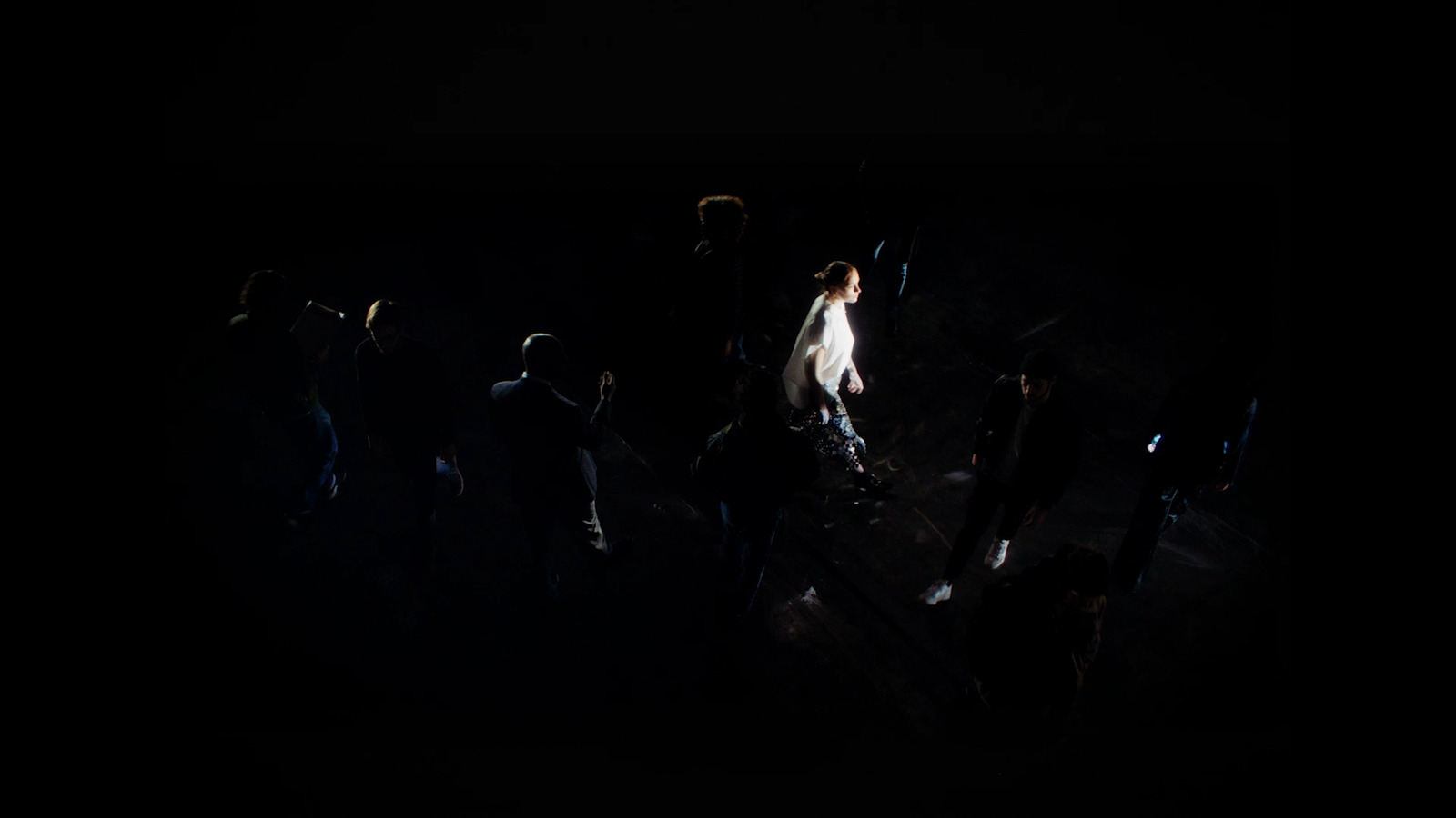 a group of people standing around in the dark