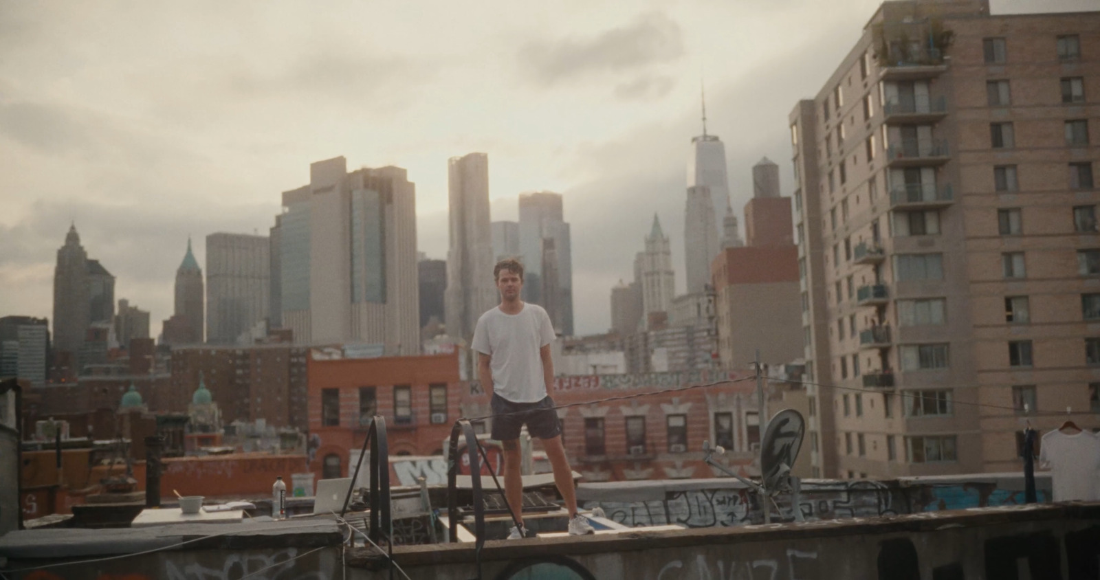 a man standing on top of a roof next to a bike