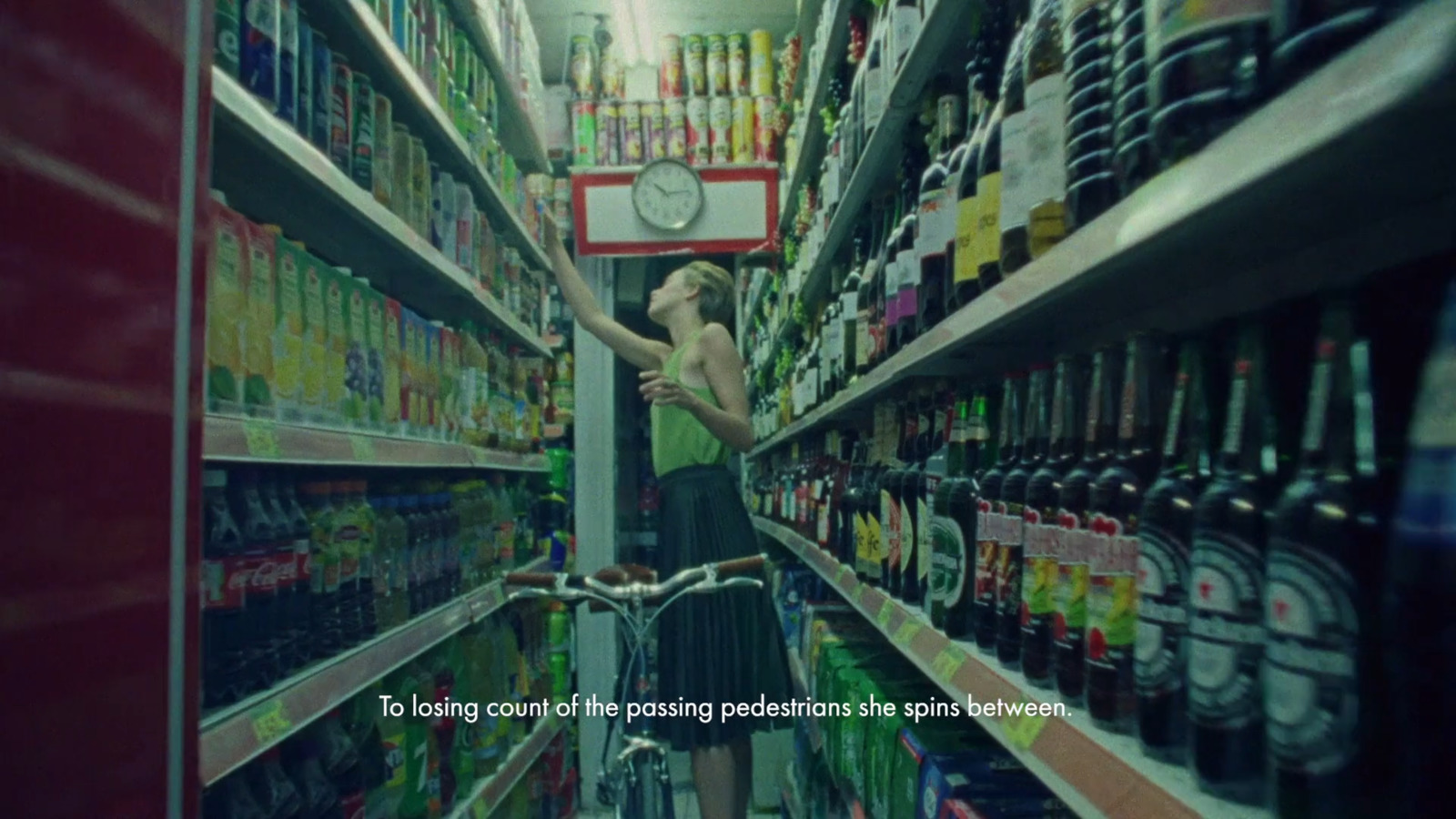 a woman is standing in a grocery store aisle