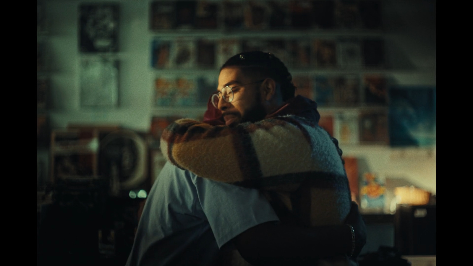 a man is holding a blanket in a room