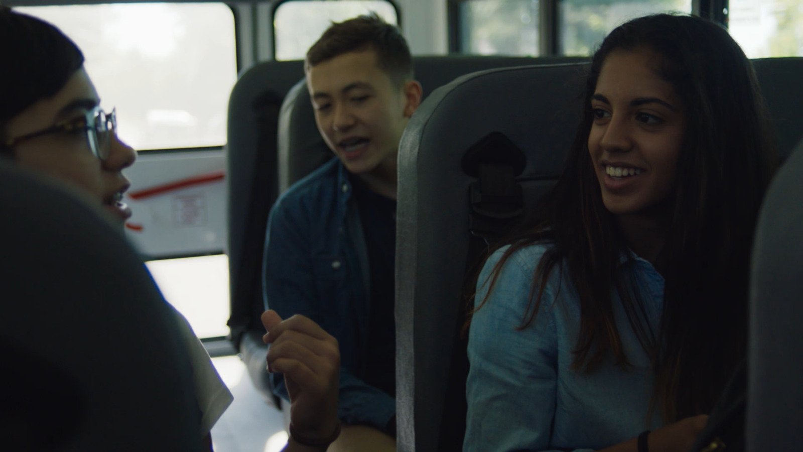 a man and a woman sitting on a bus