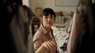 a woman looking at herself in the mirror