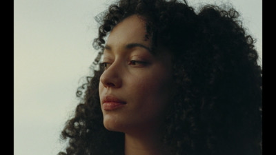 a close up of a woman with curly hair