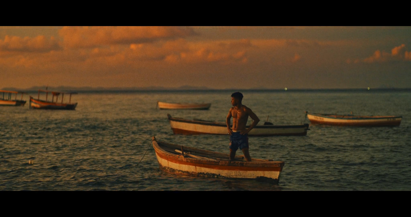 a man standing on a boat in the water