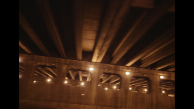 a view of the underside of a bridge at night