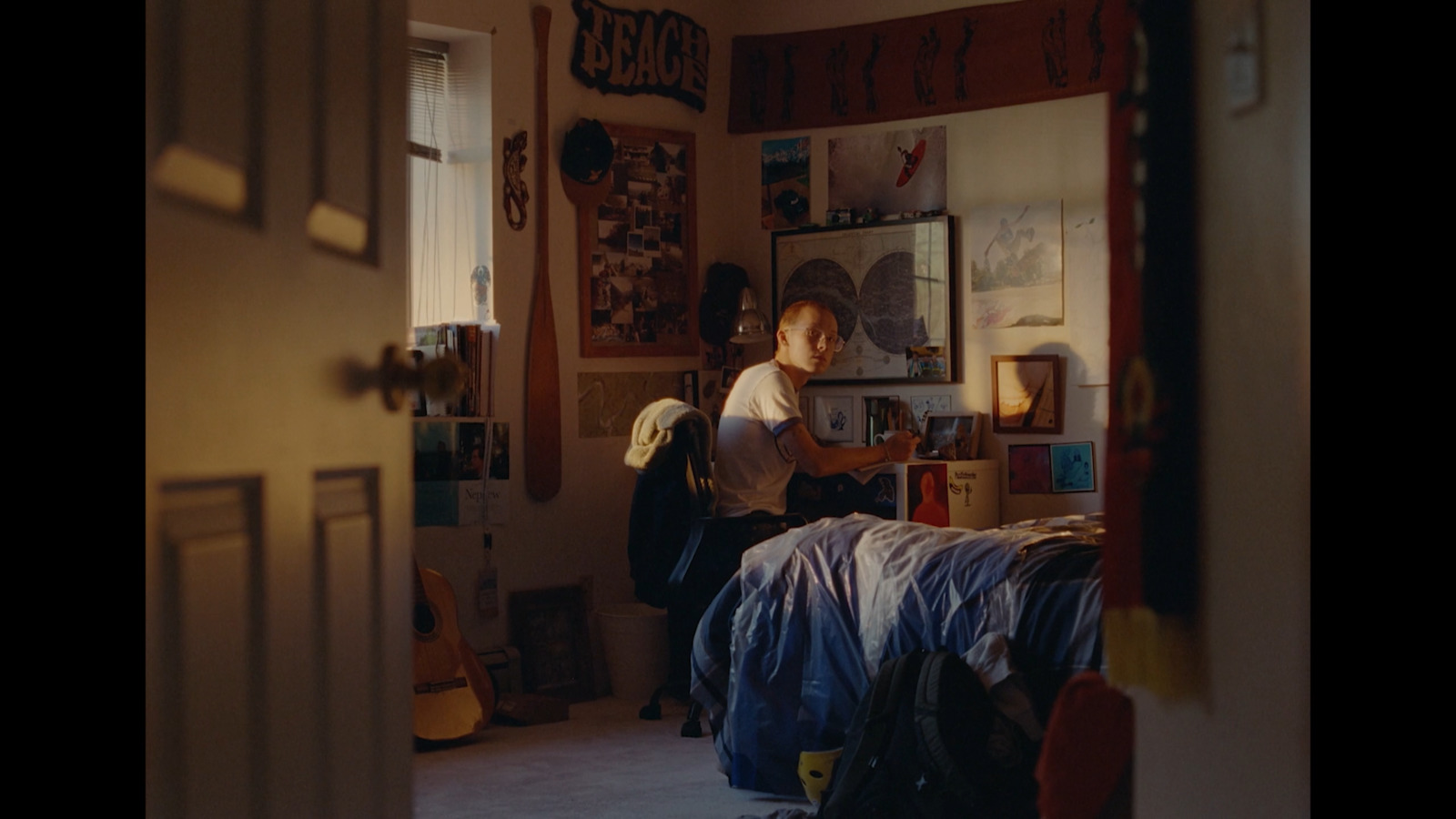 a person sitting on a bed in a room