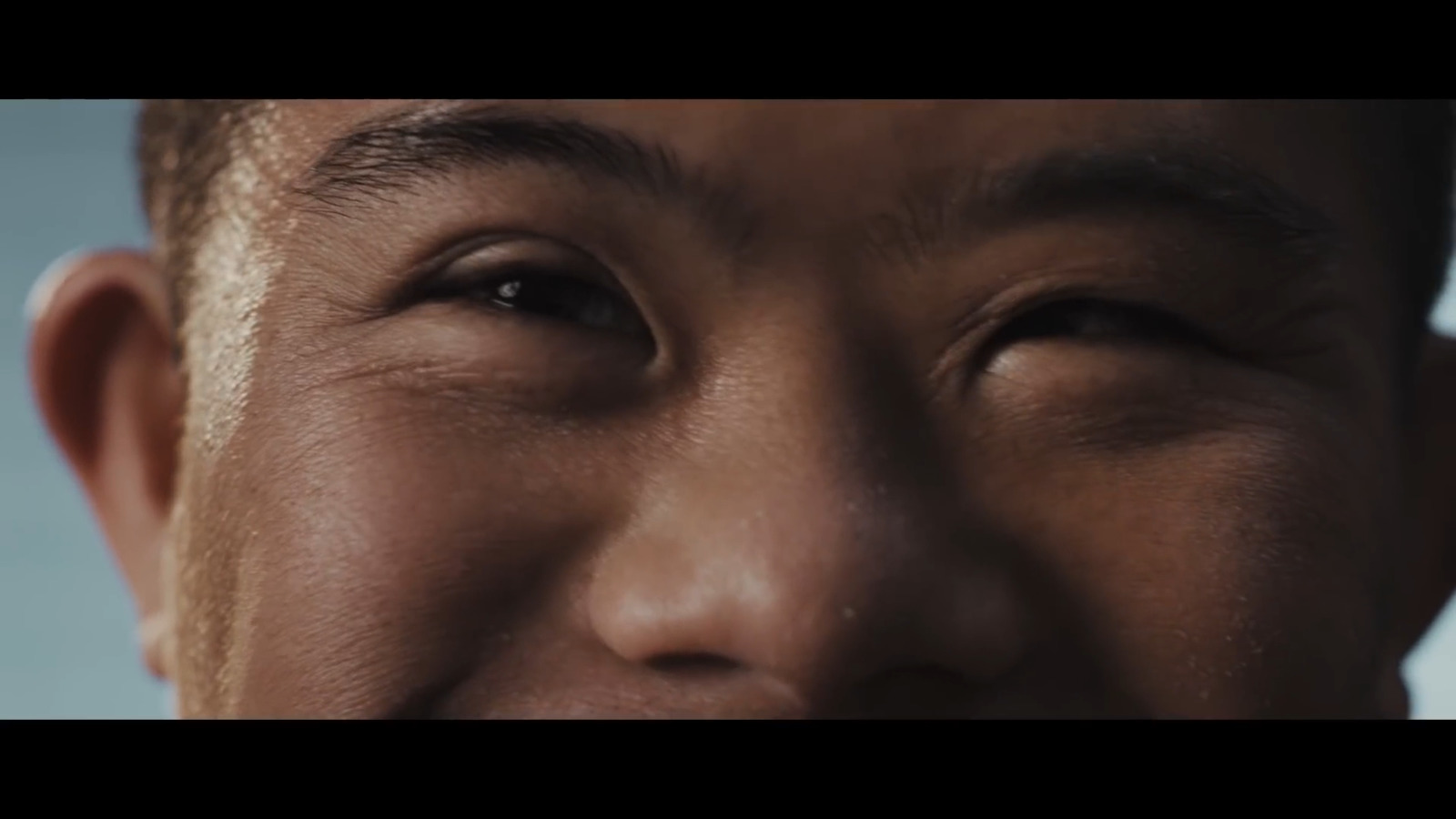 a close up of a man's face smiling