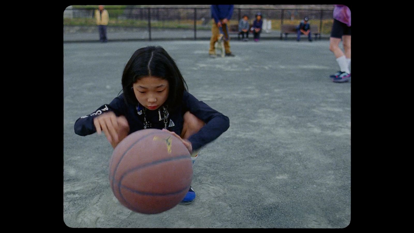 a young girl is playing with a basketball