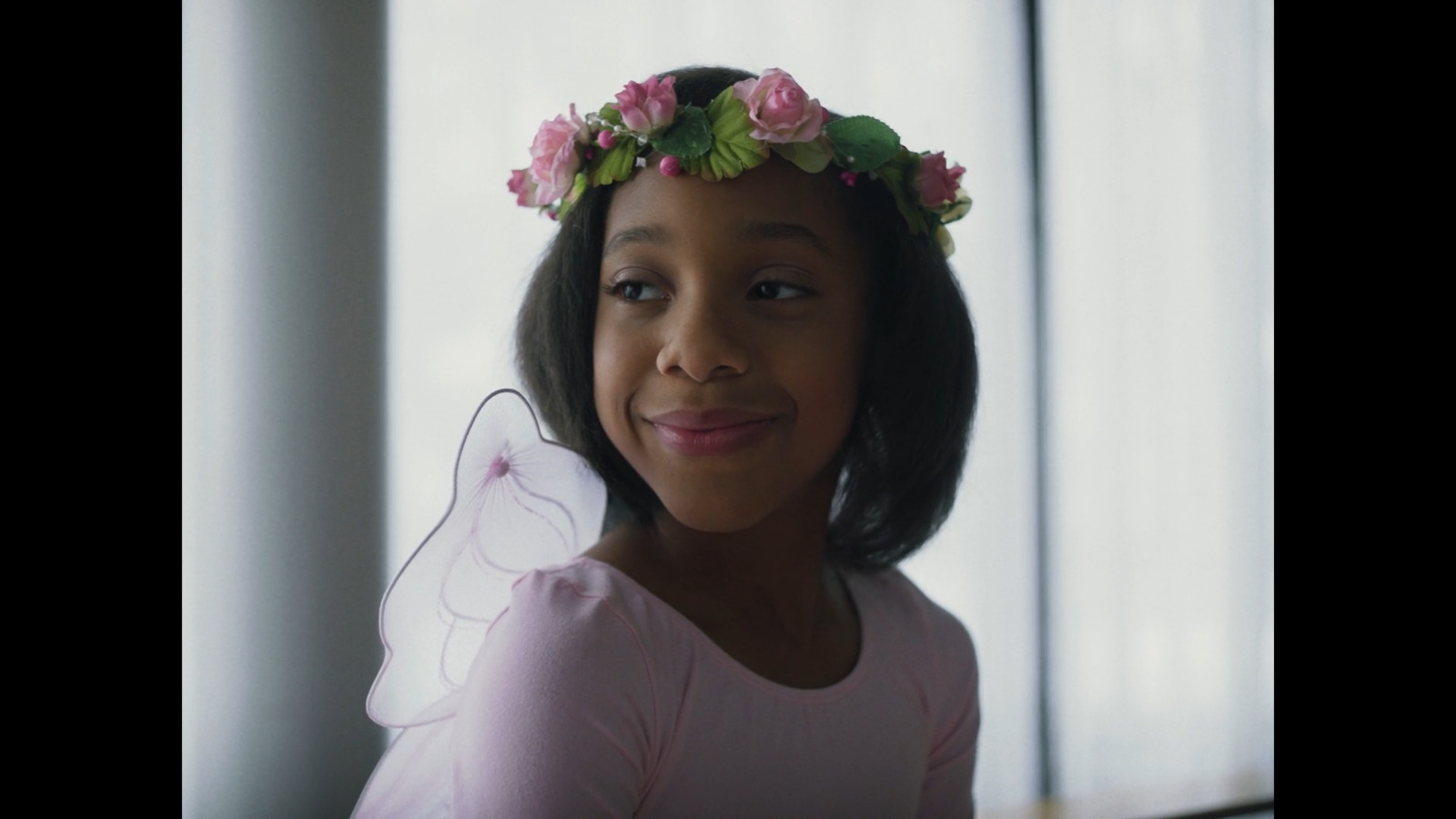 a little girl with a flower crown on her head