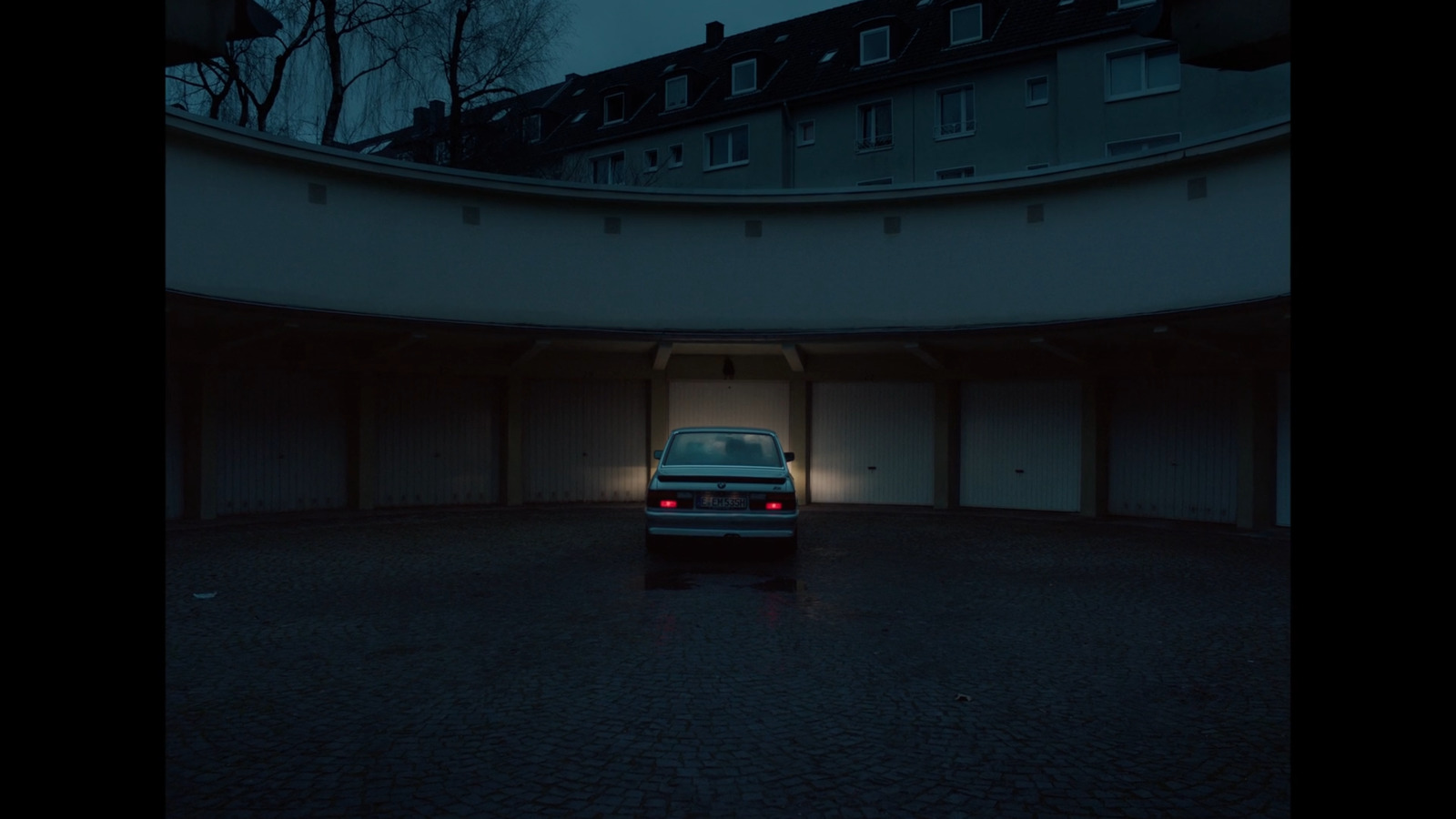 a car parked in a parking garage at night