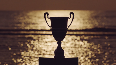 a trophy sitting on top of a metal pole