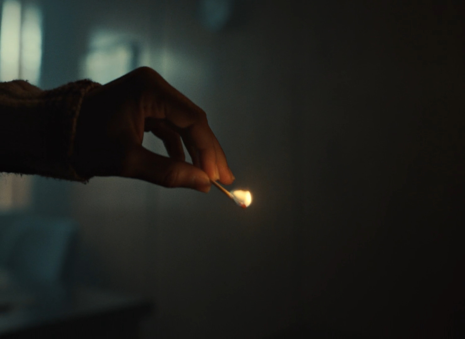 a person holding a lit match in their hand