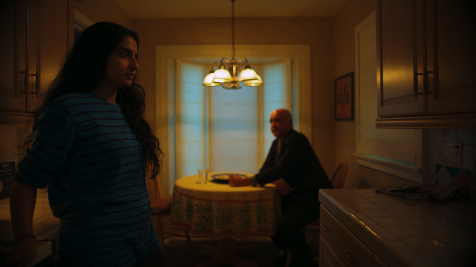 a woman standing in a kitchen next to a man