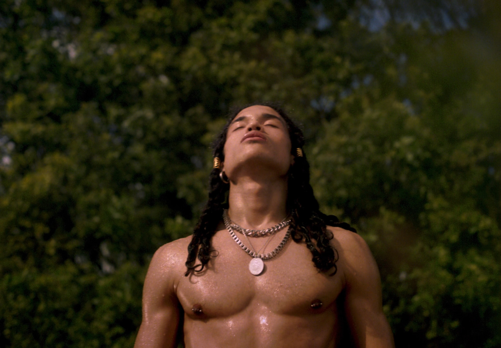 a shirtless man with long hair and no shirt on