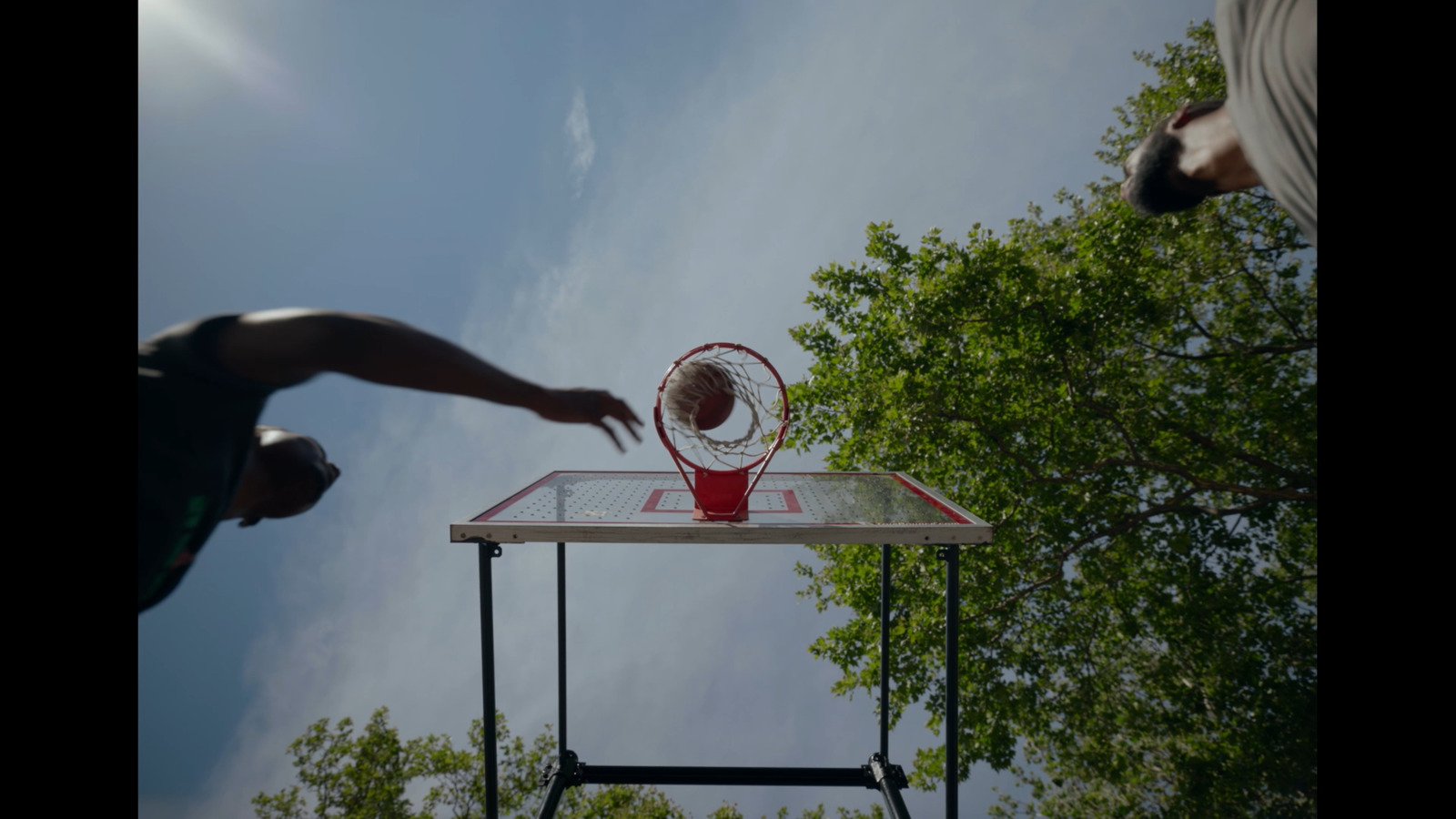 a person throwing a basketball into a basket