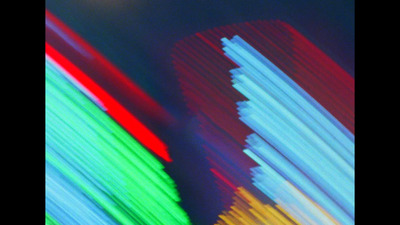 a blurry photo of colorful lines on a black background