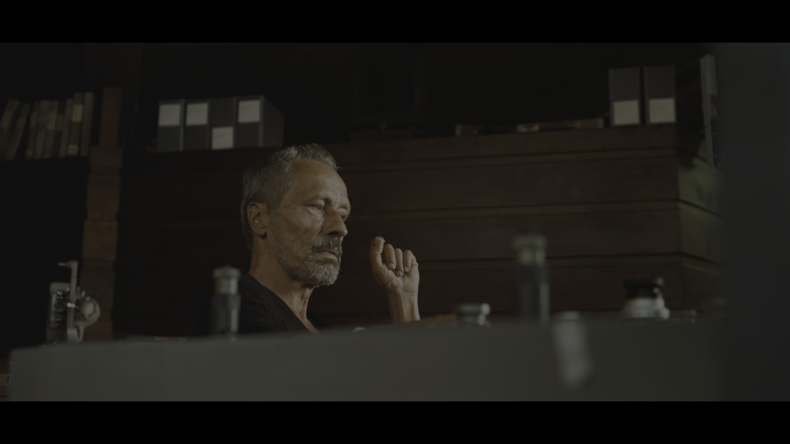 a man sitting at a table in front of a mirror