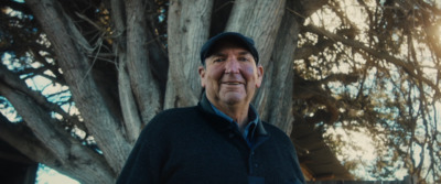 a man standing in front of a tree