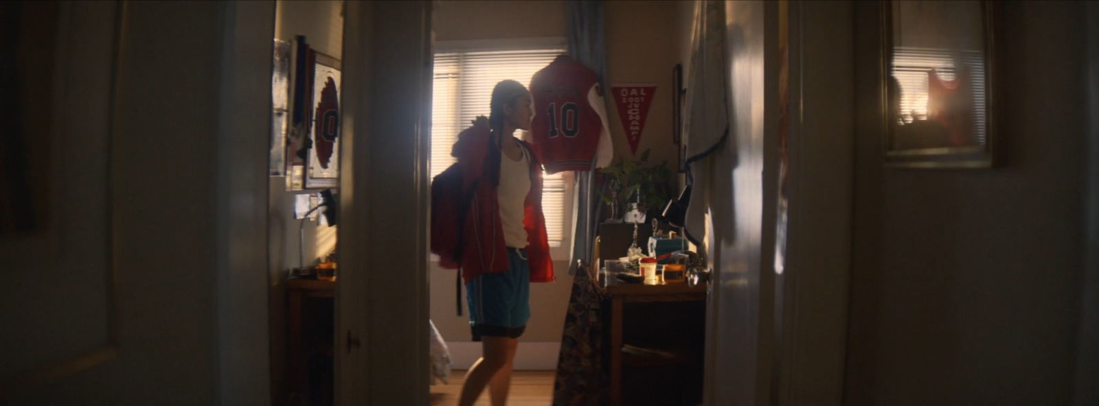 a person standing in a doorway with a red object