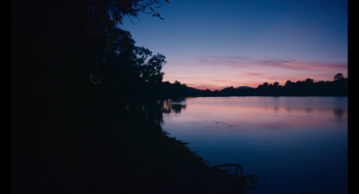 a body of water with trees in the background