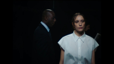 a woman in a white shirt and a man in a black suit