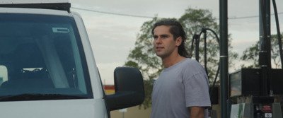 a man standing in front of a white truck