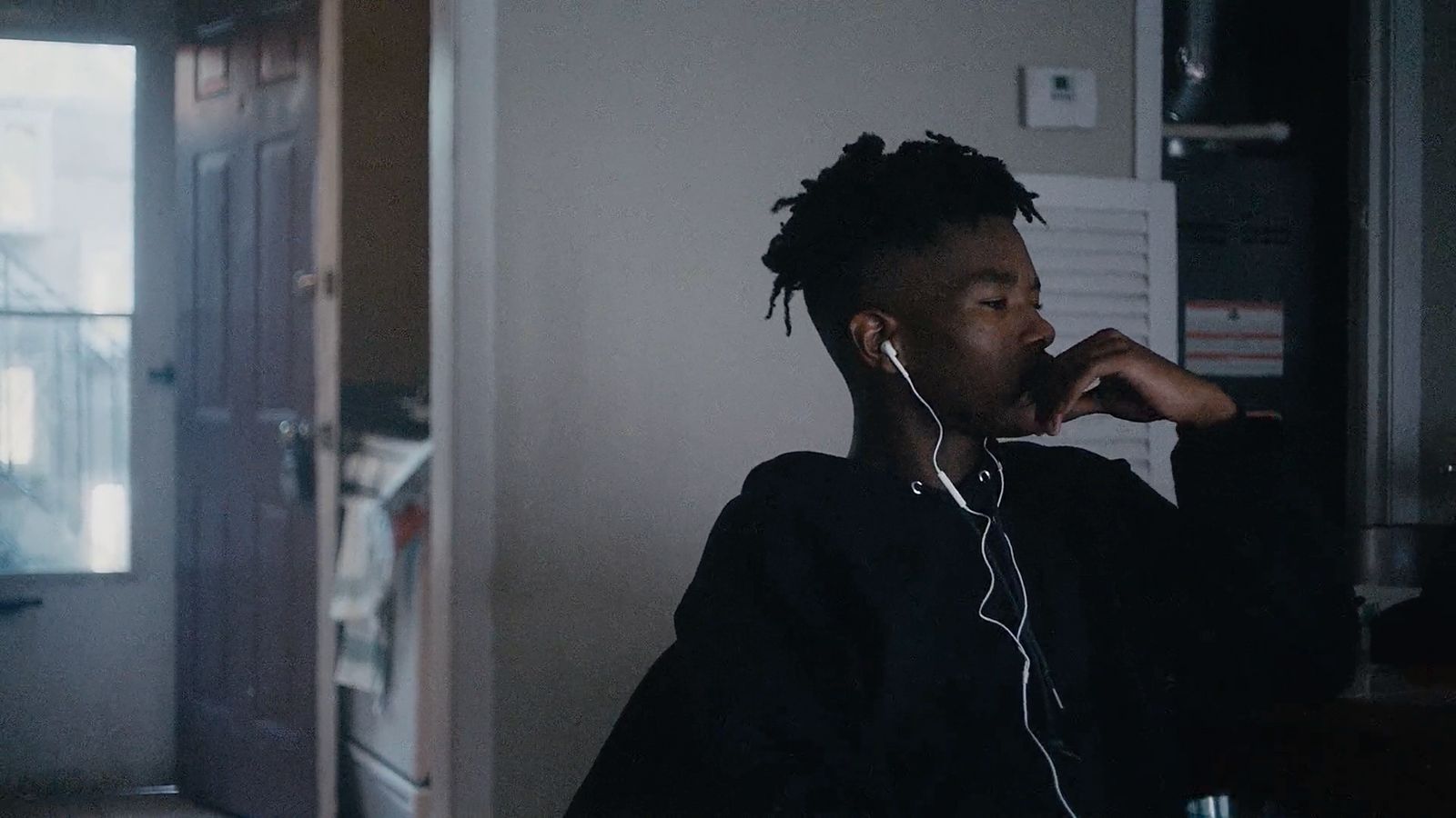 a person sitting in a room with headphones on