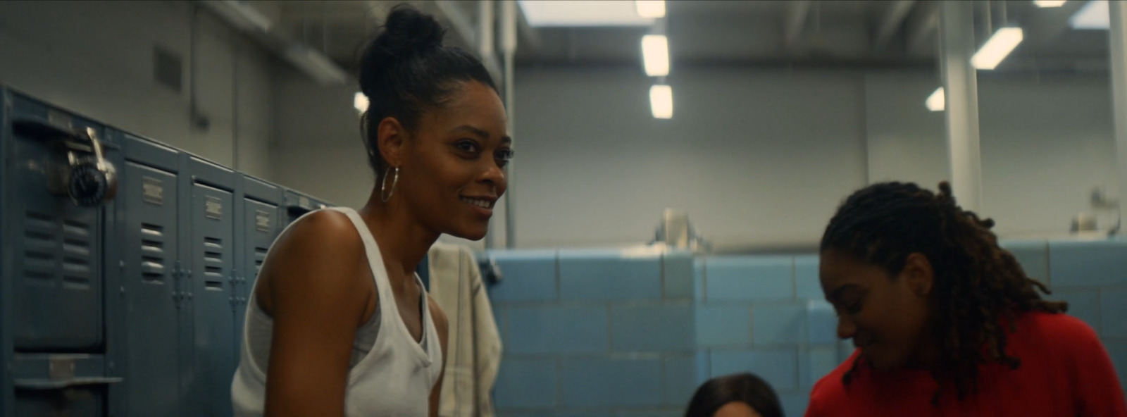 a woman standing next to another woman in a locker