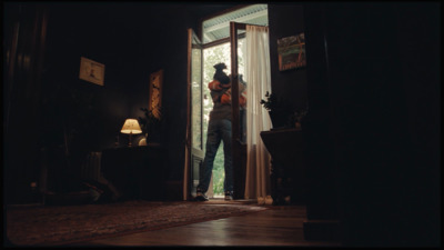 a man standing in the doorway of a house