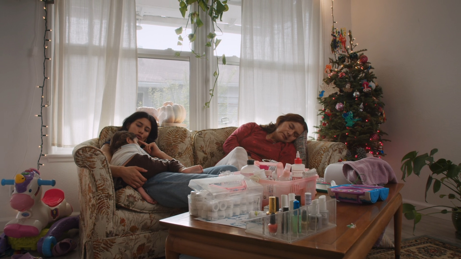 a couple of women sitting on top of a couch