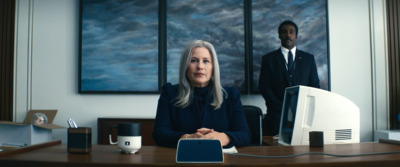 a woman sitting at a desk in front of a computer