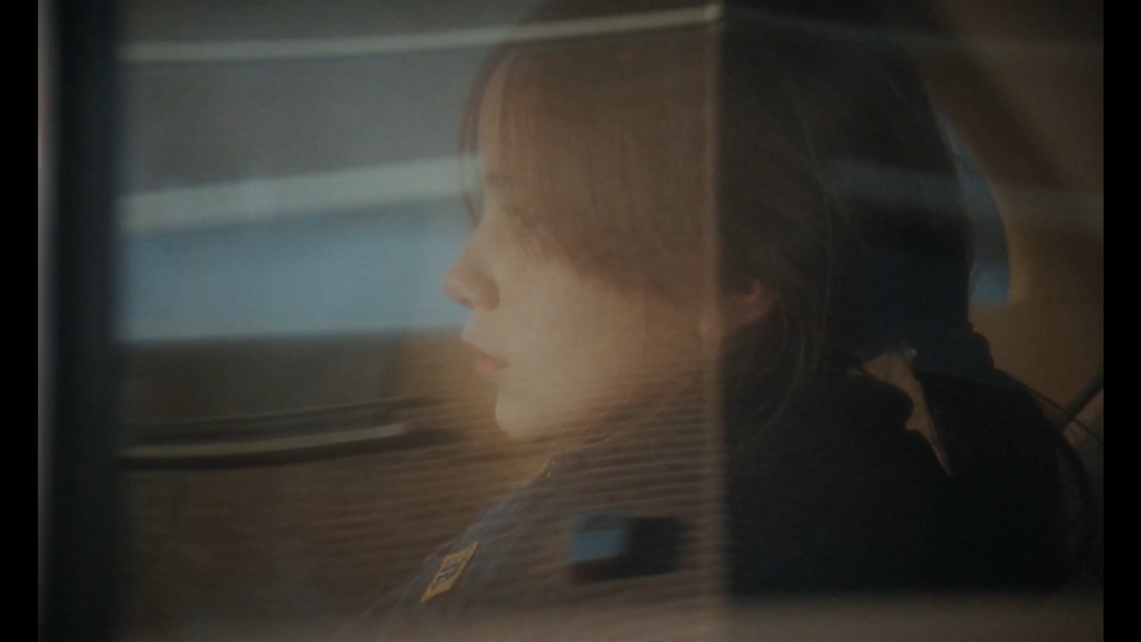 a little girl sitting in a car looking out the window