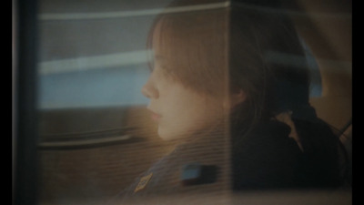 a little girl sitting in a car looking out the window