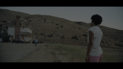 a woman standing in front of a house