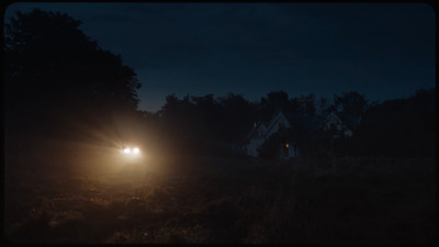 a car driving down a road at night