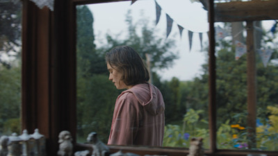 a young girl looking out of a window