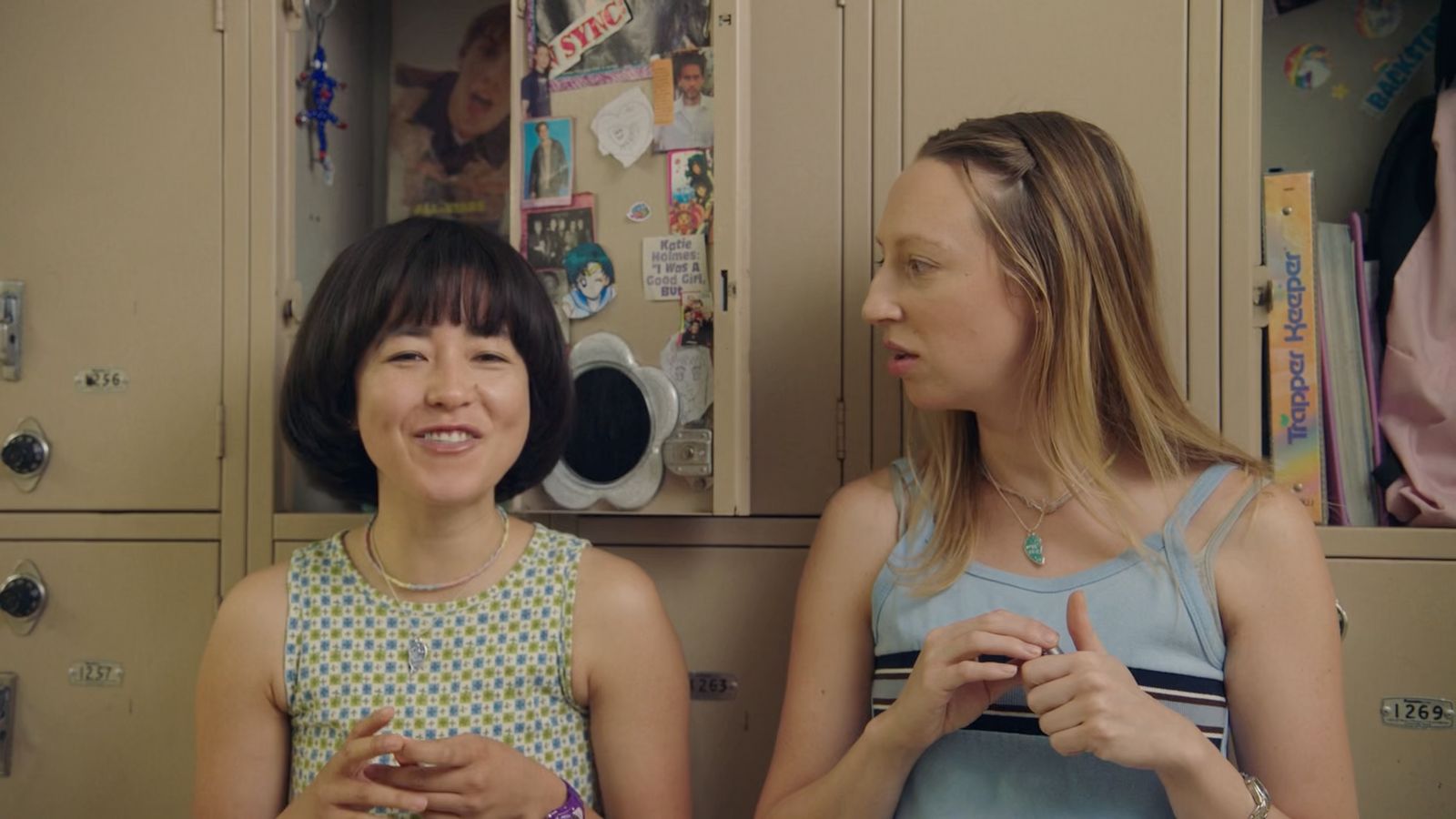 a woman standing next to a little girl in a locker