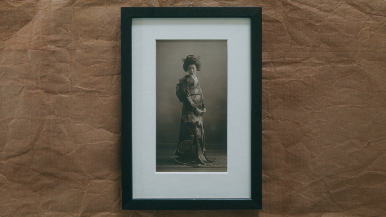 a black and white photo of a woman in a dress