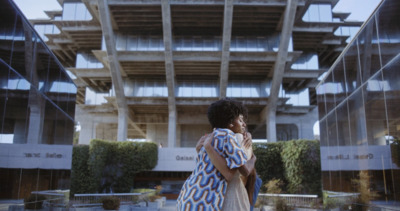 a woman standing in front of a tall building