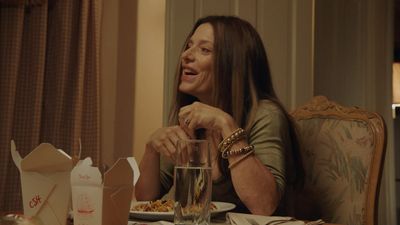 a woman sitting at a table with a plate of food