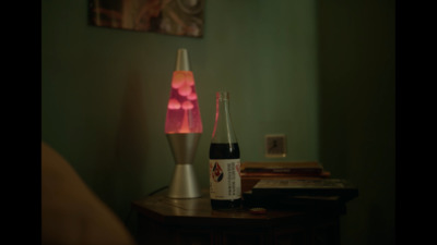 two bottles of beer sitting on top of a table