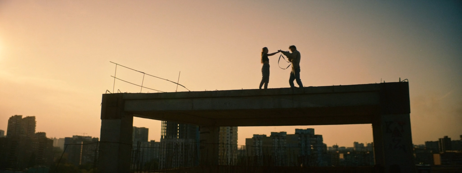 a couple of people standing on top of a bridge