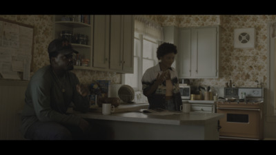 a man and a woman sitting at a kitchen counter