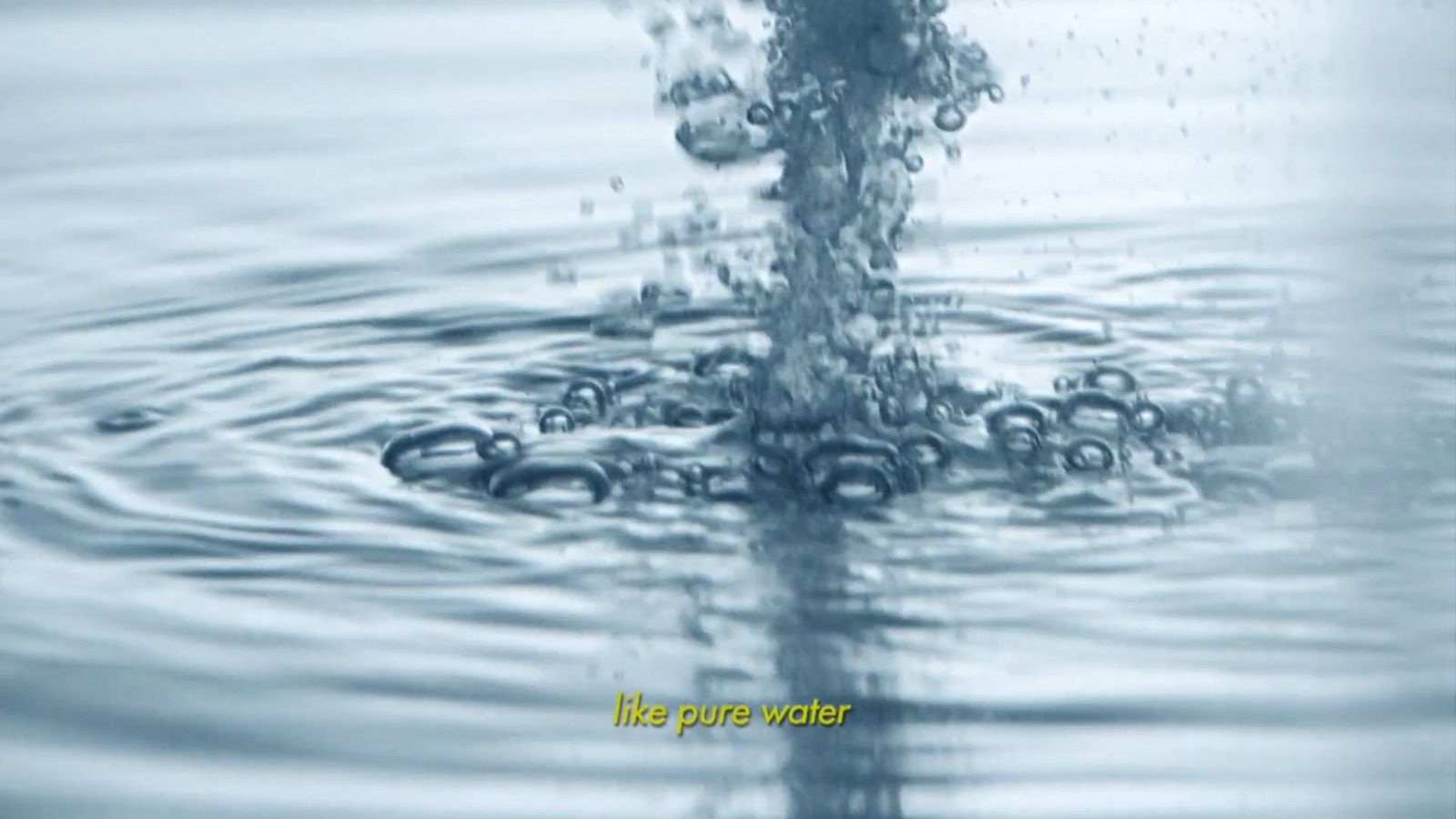 a close up of a water droplet with a blue sky in the background