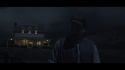 a man standing in front of a house at night