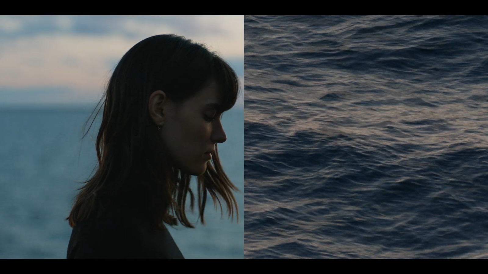 a woman standing in front of a body of water