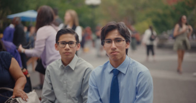 two young men sitting next to each other