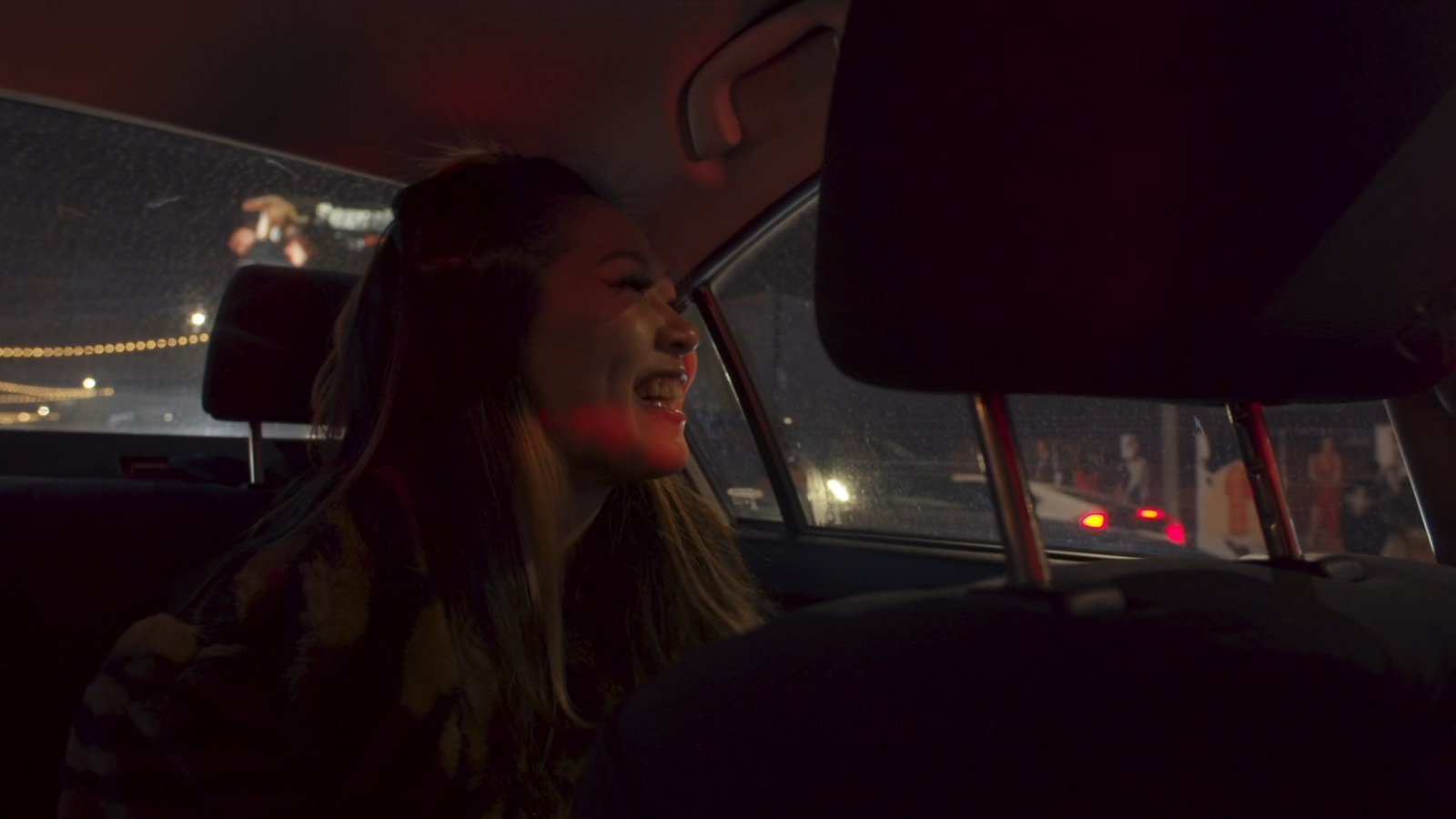 a woman sitting in the back seat of a car