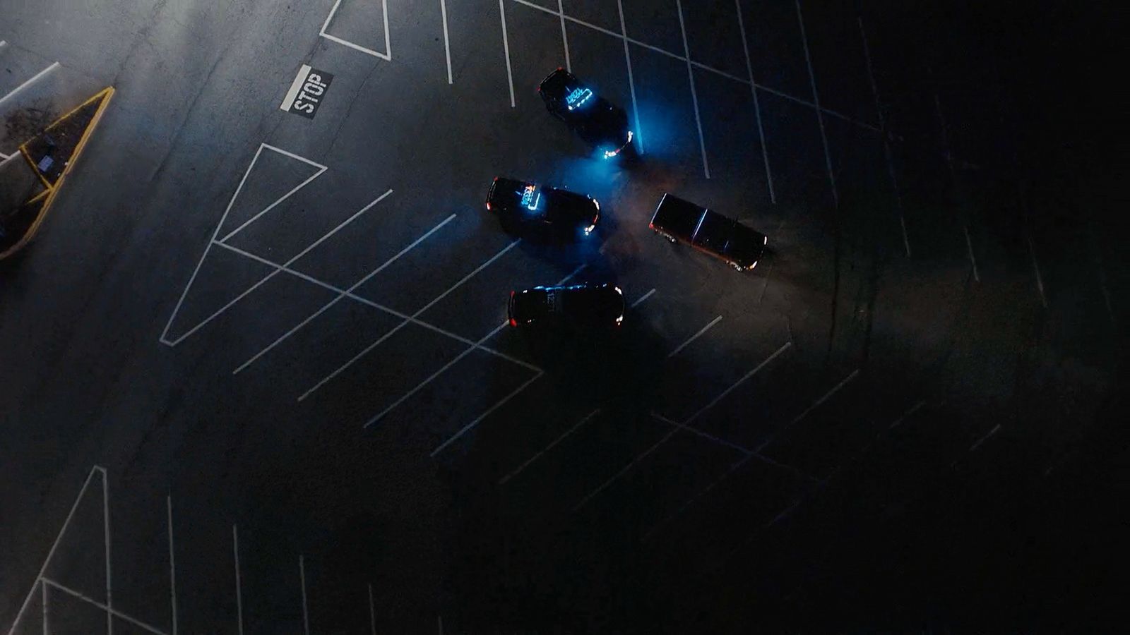 a group of cars driving down a street at night